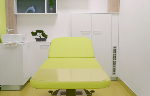 green examination table in doctor's office