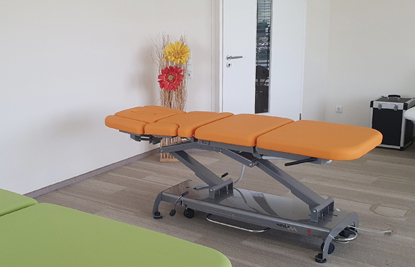 therapy table with orange upholstery in showroom