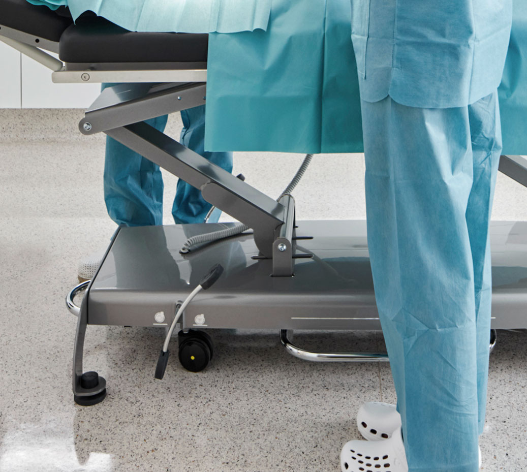 doctor and nurse standing by the base of surgery table